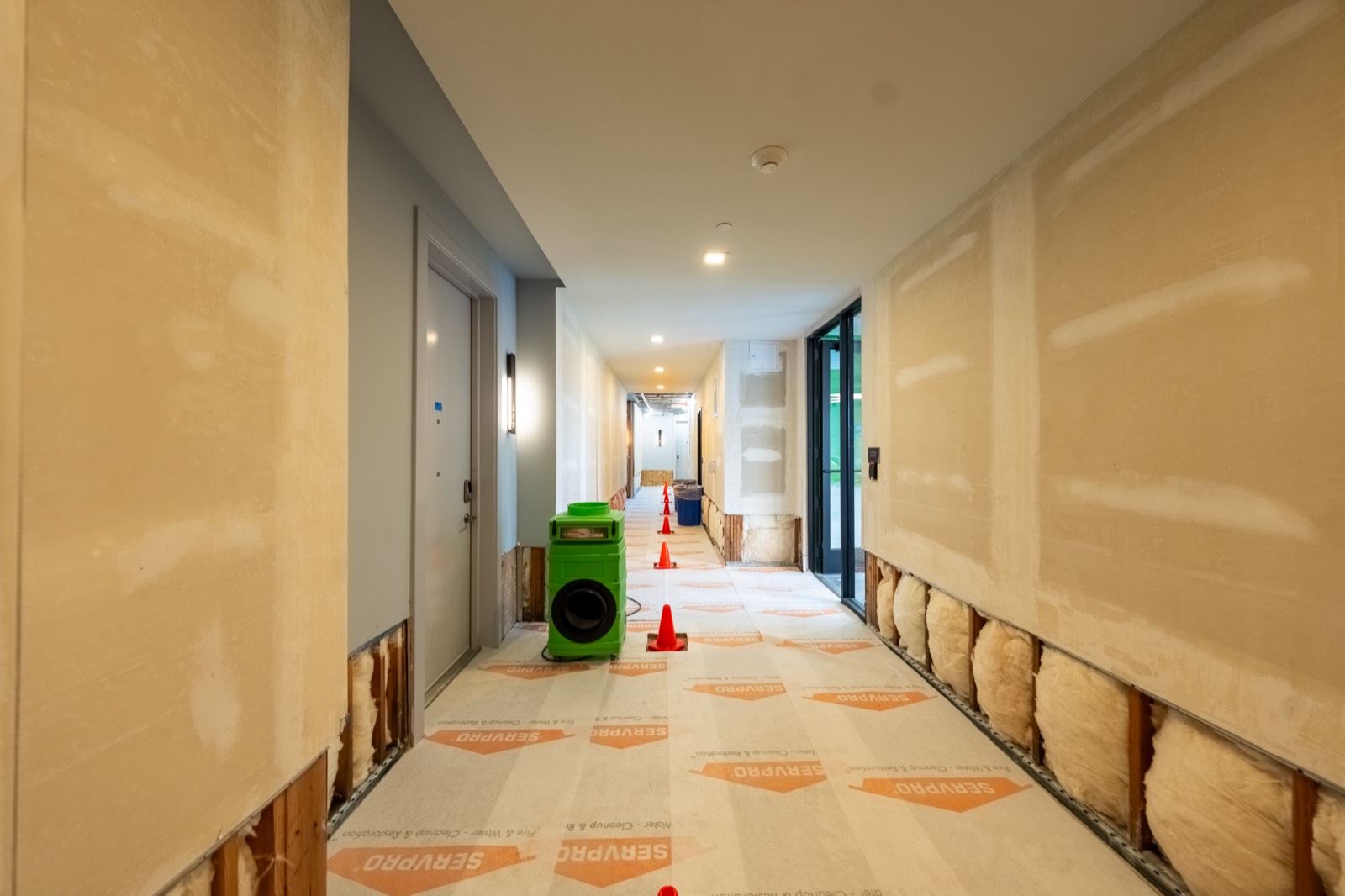 Commercial corridor build-out in progress, framing and drywall, September 2026