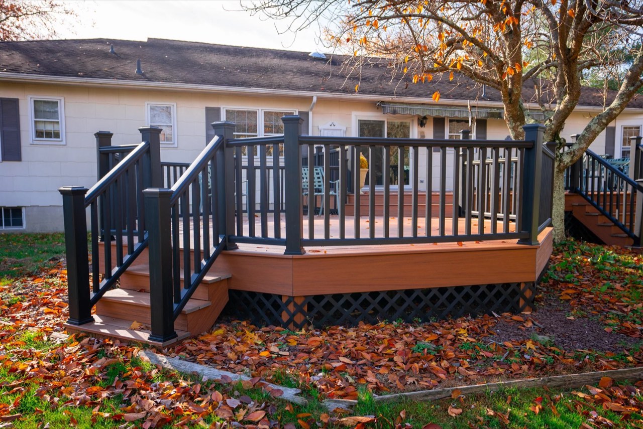 Composite deck with black railings behind a ranch home in Marlboro