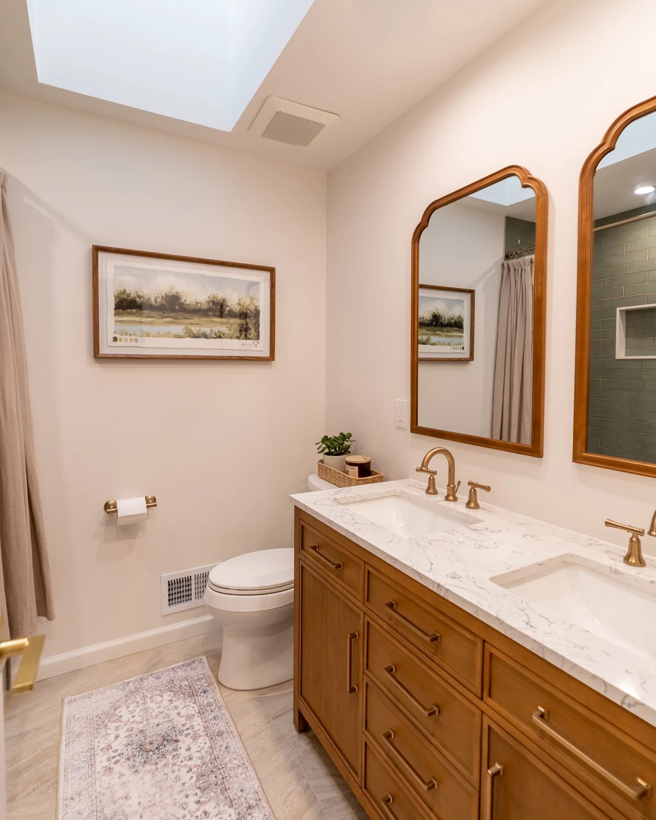Double vanity bath with wood cabinet and brass faucets