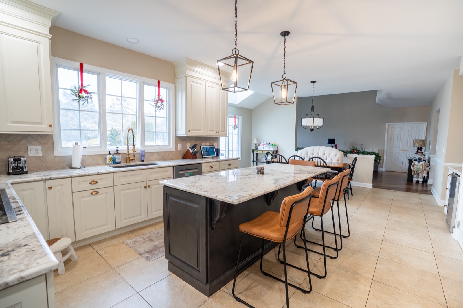 Cream kitchen with dark island and lantern pendants