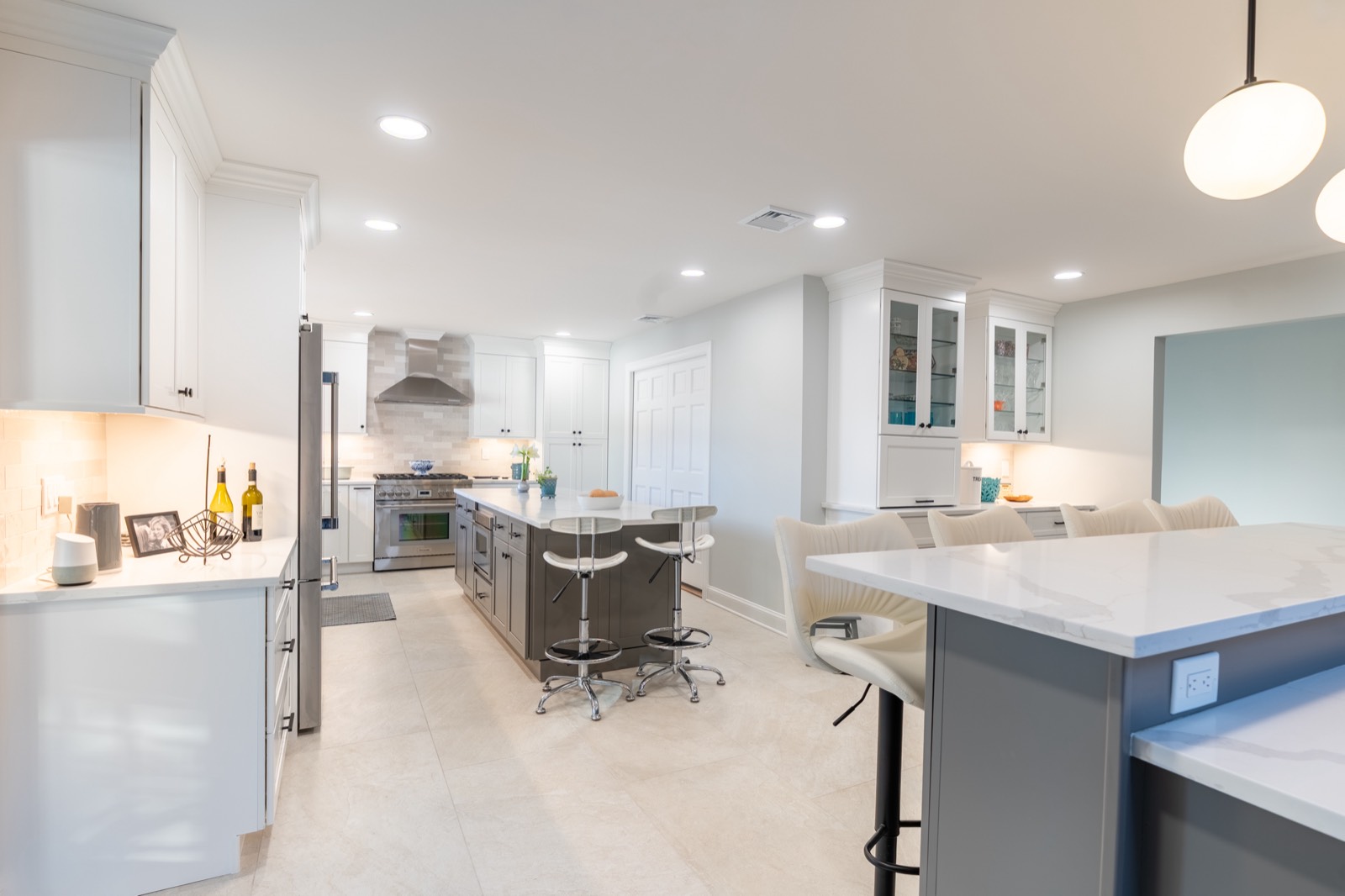 White kitchen with grey island and pendant lights, finished January 2026