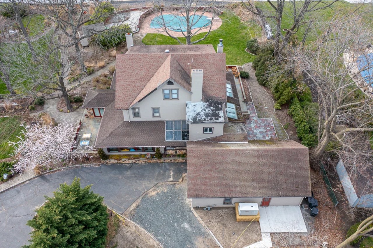 Before: the worn brown roof seen from a drone