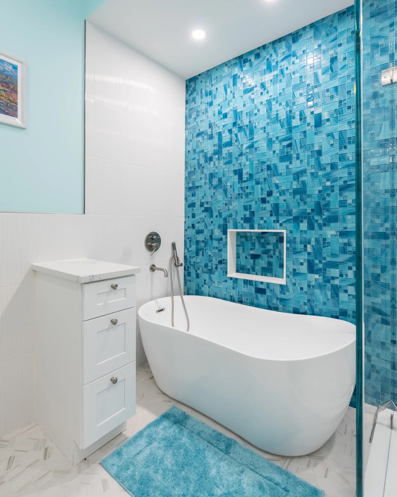 Bathroom with blue mosaic feature wall and freestanding tub